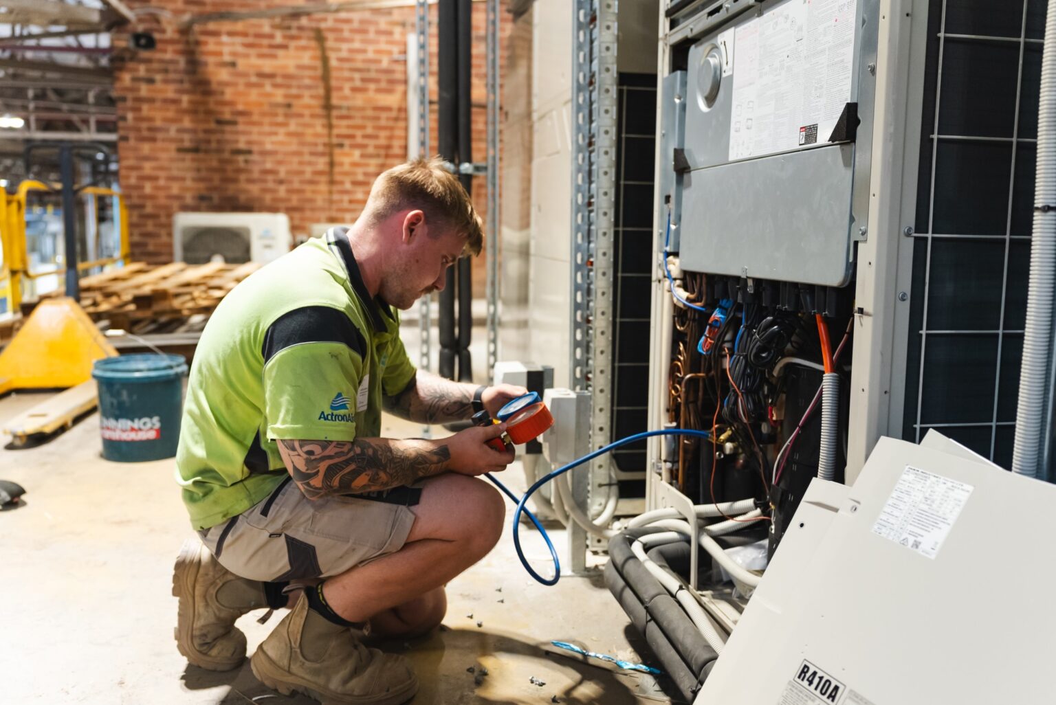 Amped Up Air technician servicing a commercial air conditioning unit
