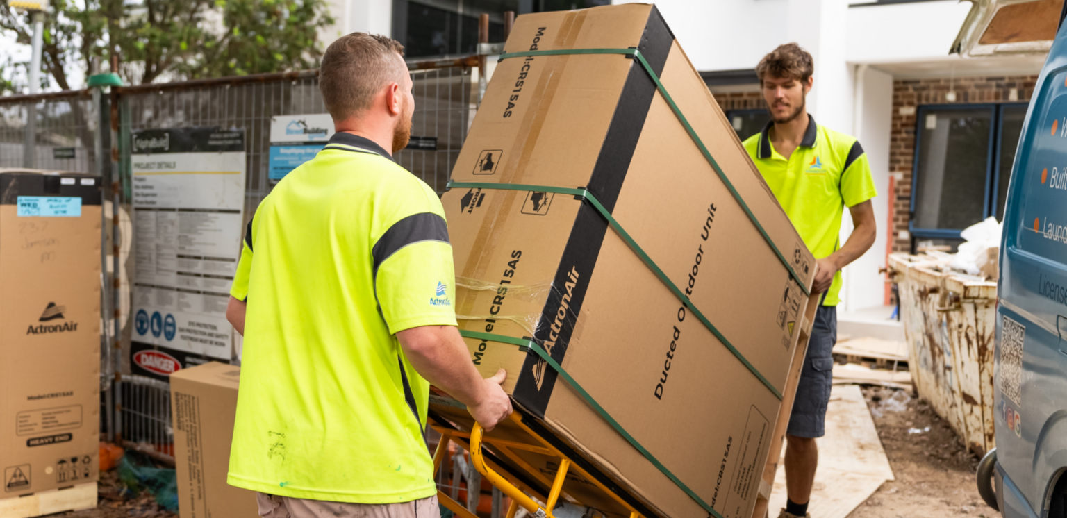 Amped Up Air technicians delivering a new air conditioning system to a Western Sydney home