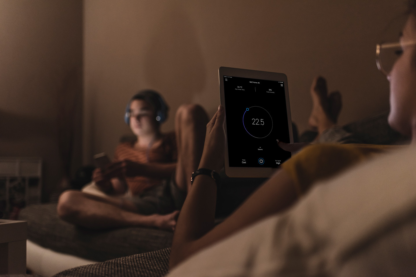 Homeowner controlling their air conditioning from a smart home app on a tablet