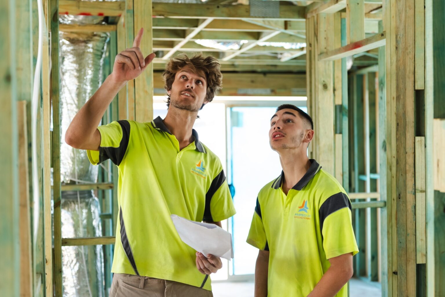 Amped Up Air technicians planning an installation on site